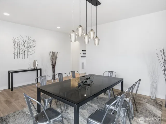 a view of a dining room with furniture and wooden floor