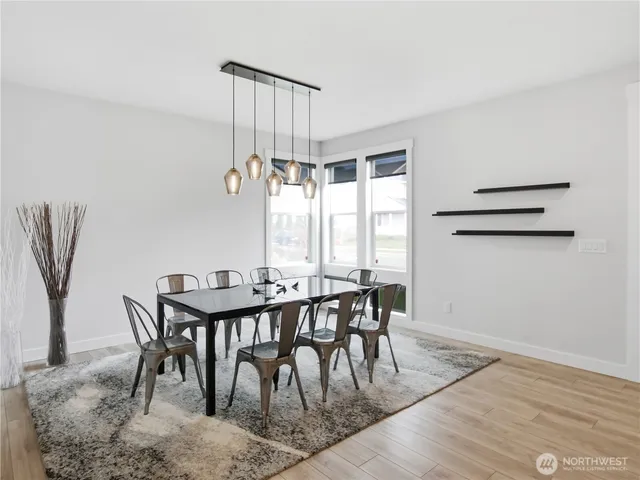 a view of a dining room with furniture and window