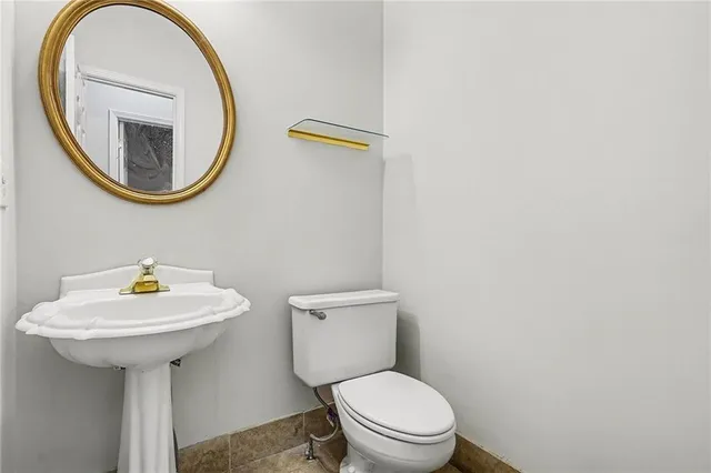 a white toilet sitting next to a bathroom sink