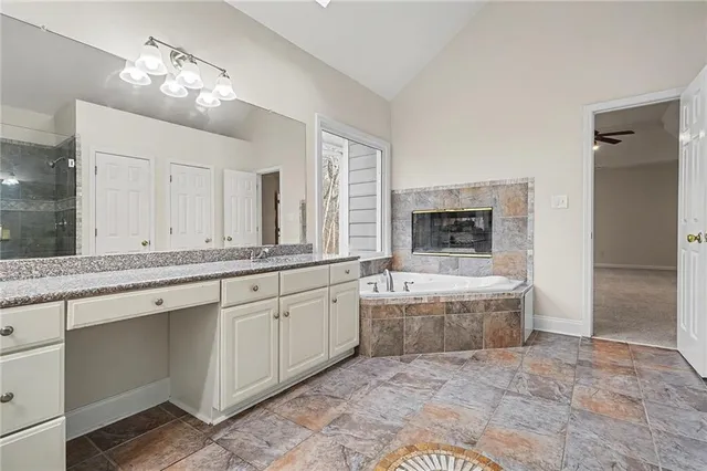 a large bathroom with a large tub and double vanity sink