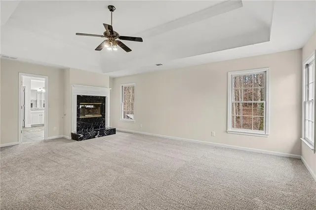 a view of an empty room with a window and a ceiling fan