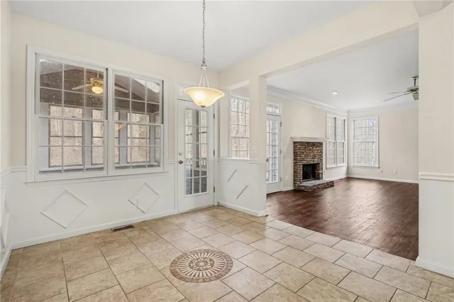 a view of an empty room with window and fire place