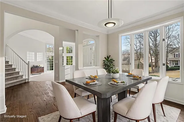 a view of a dining room with furniture window and wooden floor
