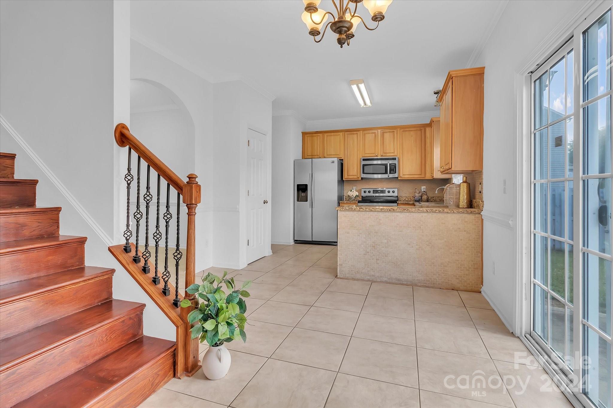 1004 Kipling Court Indian Trail, NC 28079 - Photo 11 of 42 a view of a kitchen with furniture and staircase