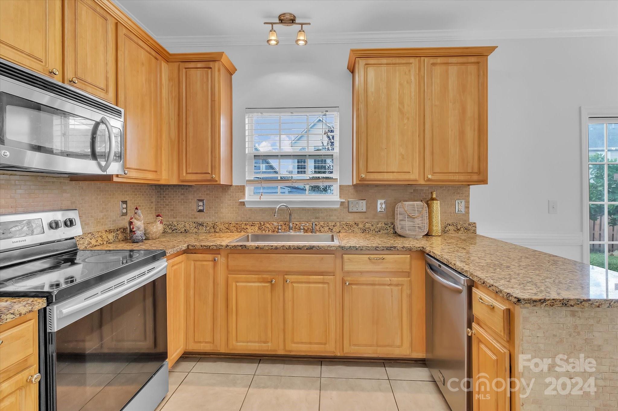 1004 Kipling Court Indian Trail, NC 28079 - Photo 14 of 42 a kitchen with a sink stove and cabinets