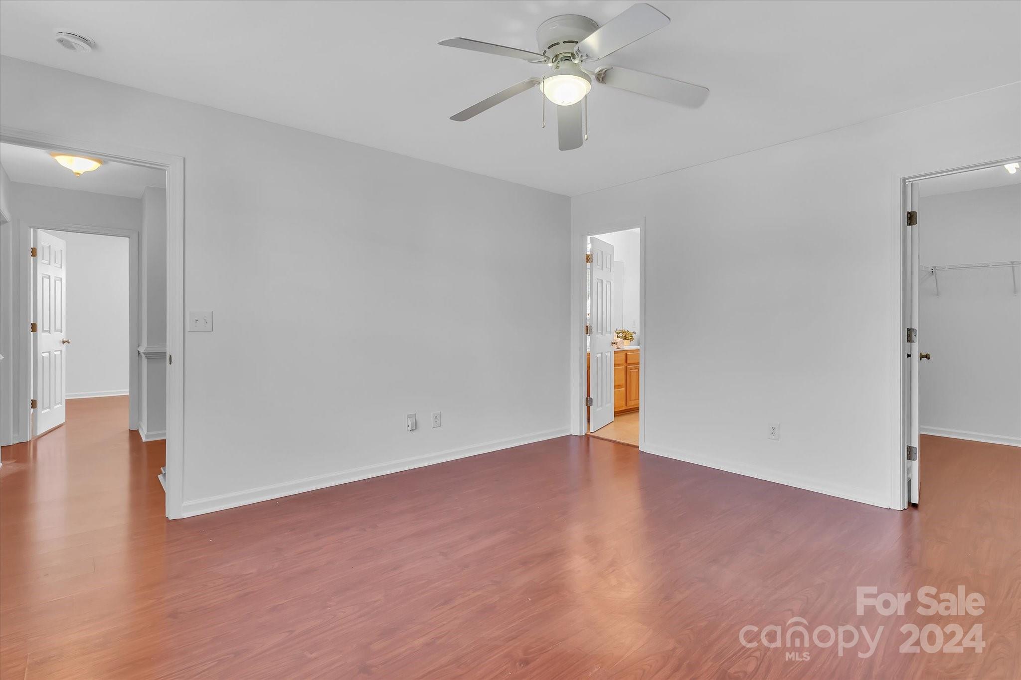 1004 Kipling Court Indian Trail, NC 28079 - Photo 25 of 42 an empty room with wooden floor and ceiling fan