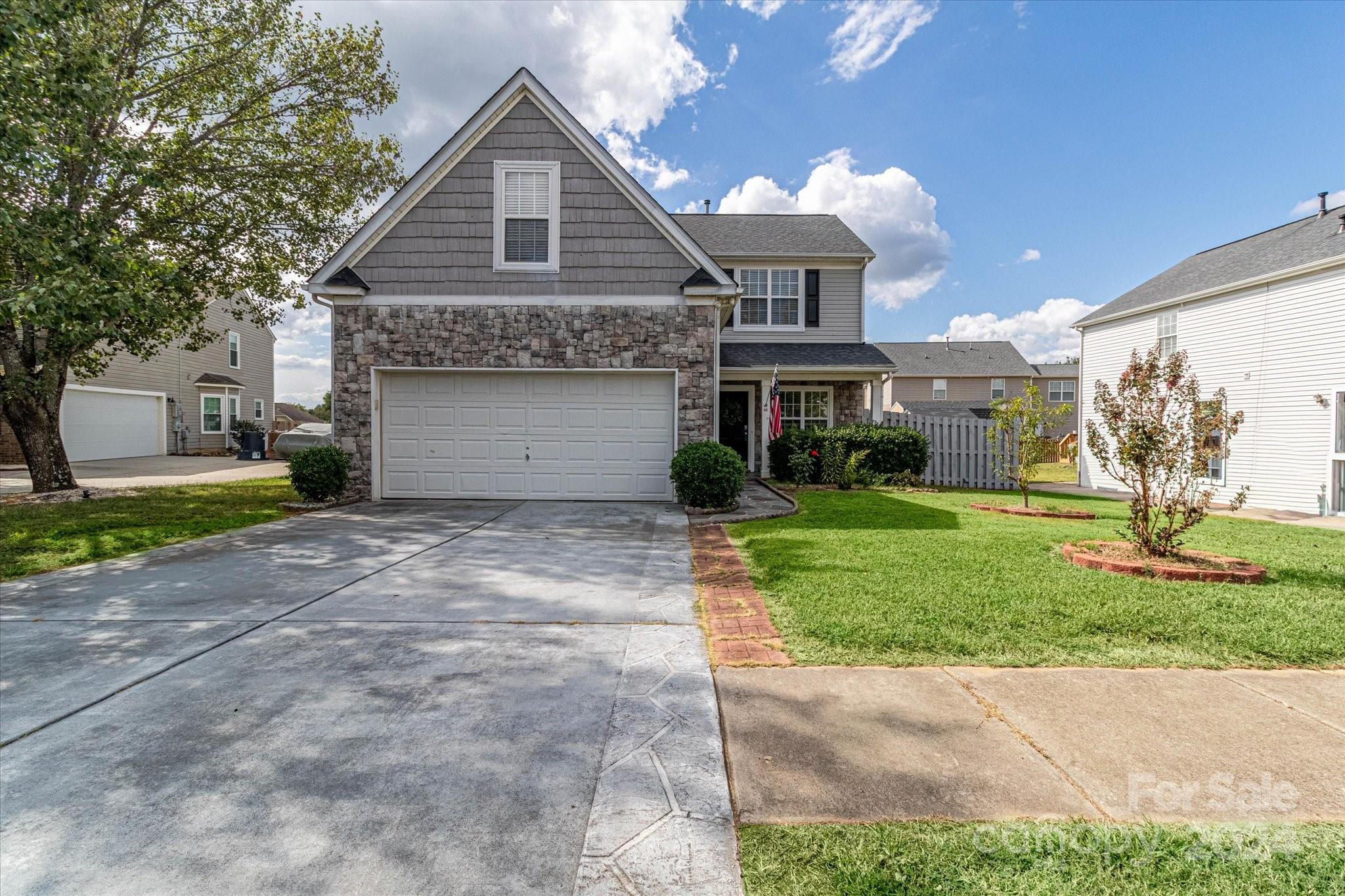 1004 Kipling Court Indian Trail, NC 28079 - Photo 3 of 42 a front view of a house with a yard and garage