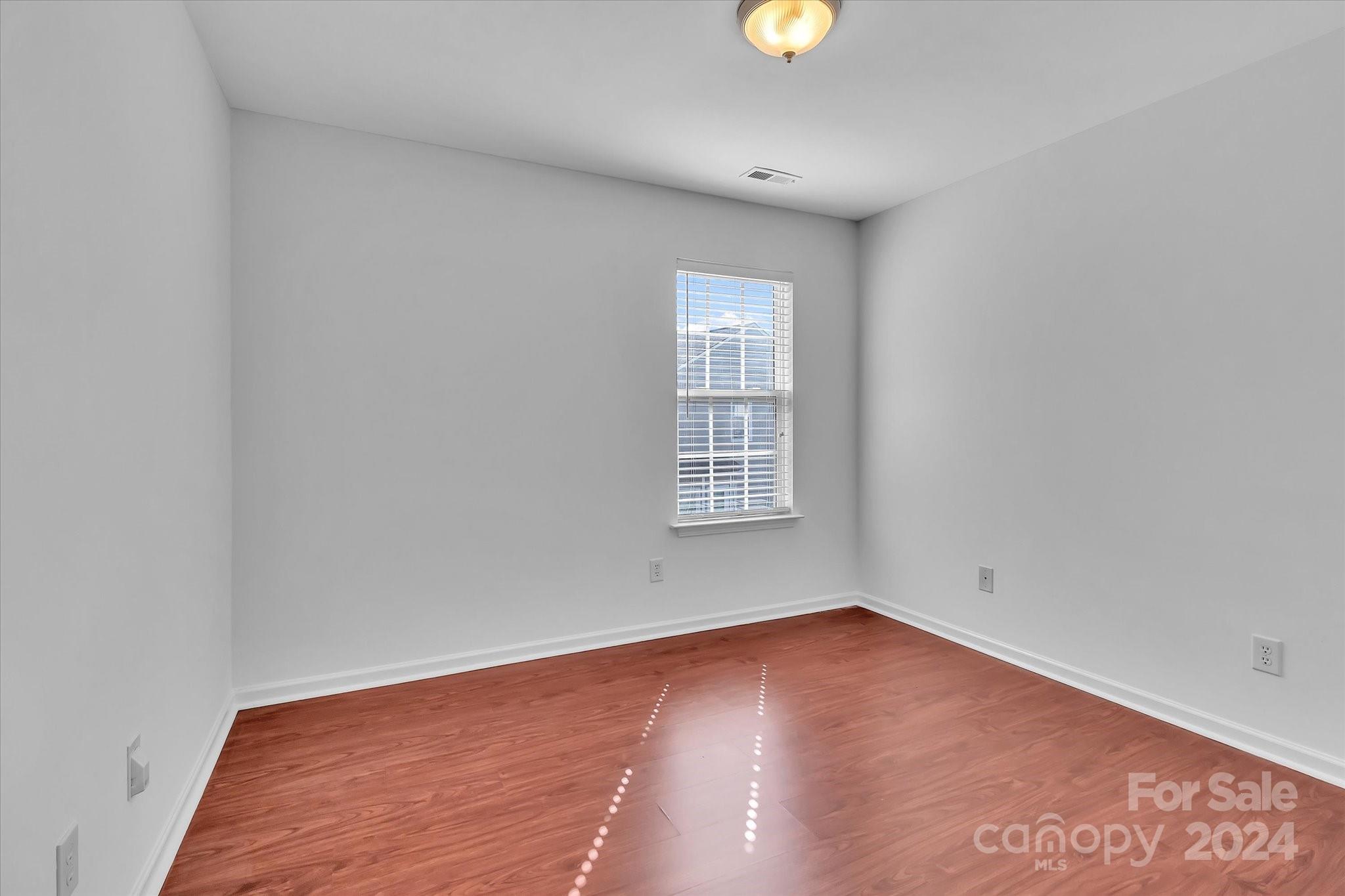 1004 Kipling Court Indian Trail, NC 28079 - Photo 35 of 42 an empty room with wooden floor and windows