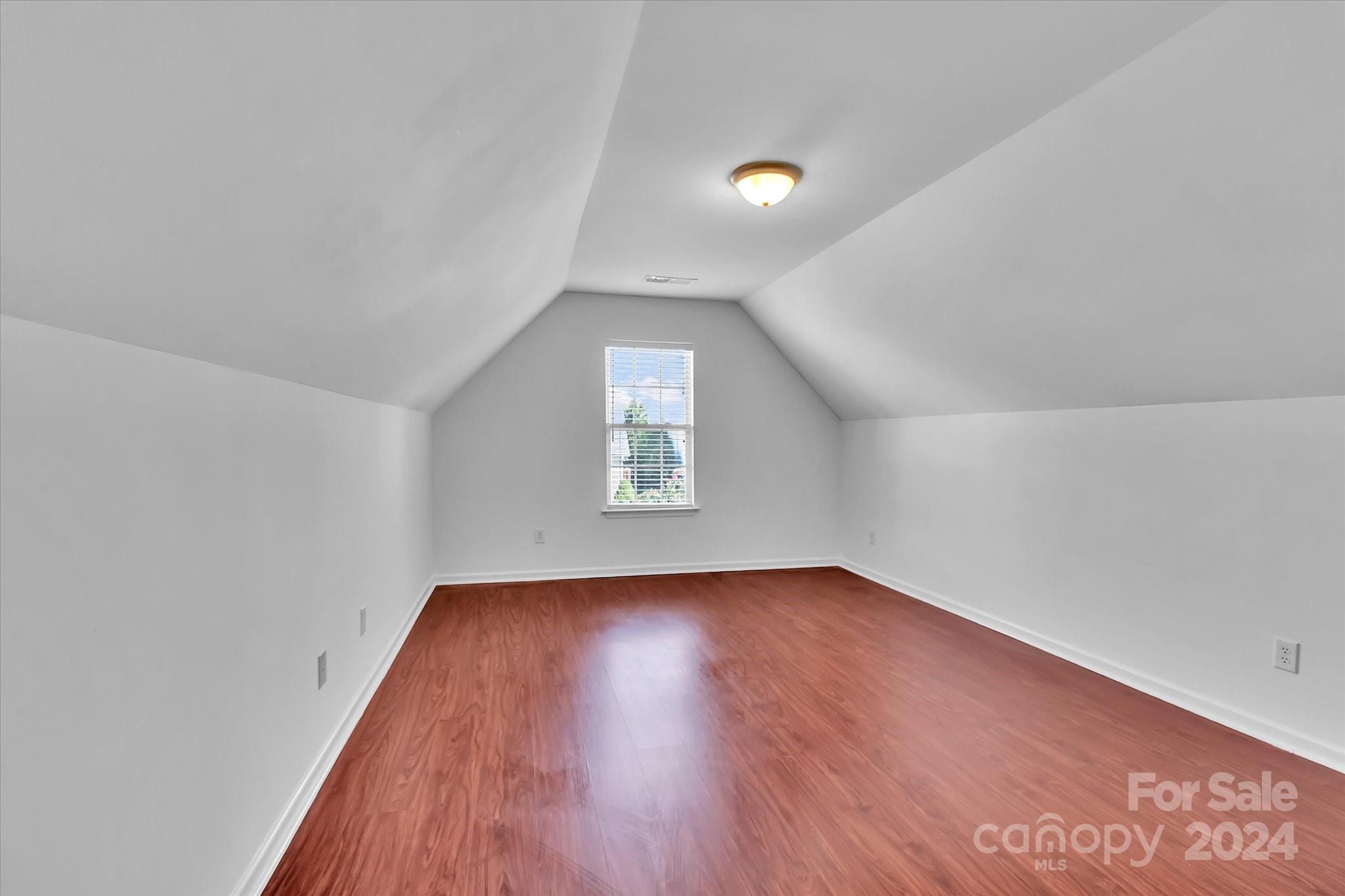 1004 Kipling Court Indian Trail, NC 28079 - Photo 37 of 42 an empty room with wooden floor and windows
