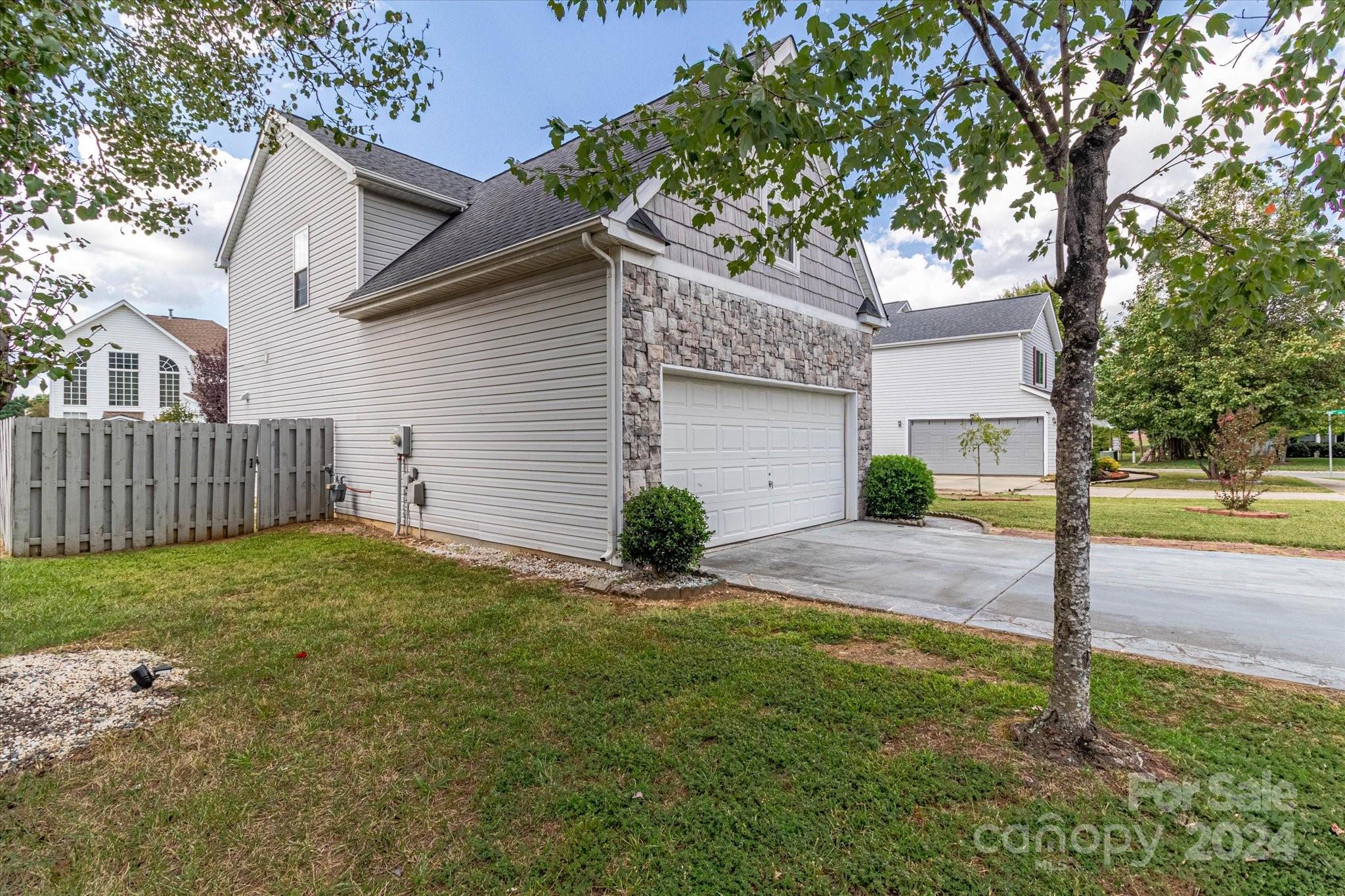 1004 Kipling Court Indian Trail, NC 28079 - Photo 5 of 42 a view of a house with backyard and tree