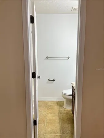 a bathroom with a granite countertop shower and a toilet
