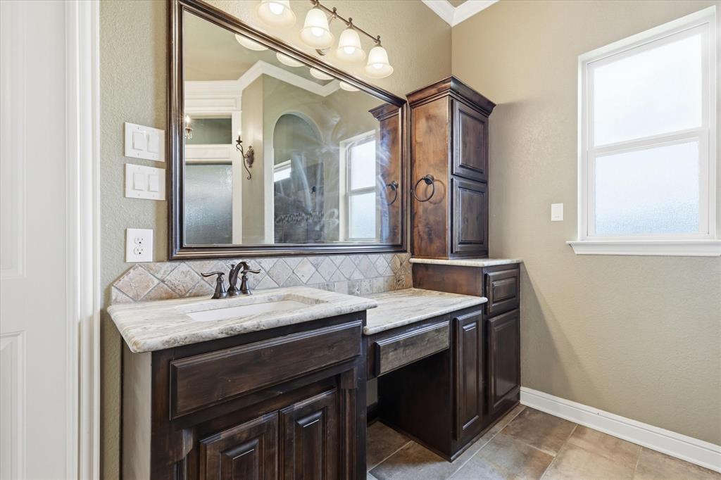 160 Vista Ridge North Decatur, TX 76234 - Photo 23 of 40 a bathroom with a granite countertop sink a large mirror and a vanity