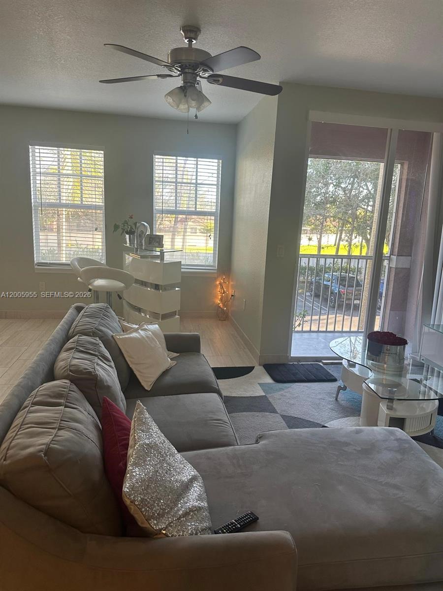6920 West Sample Road, Unit 6920 Pompano Beach, FL 33063 - Photo 23 of 30 a living room with furniture and a window