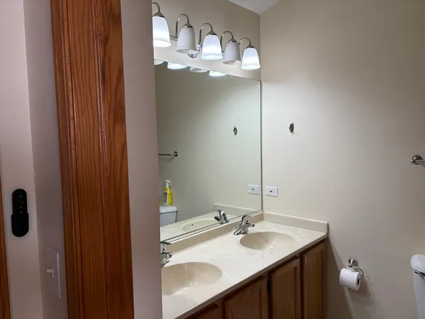 a bathroom with a sink vanity granite and a mirror