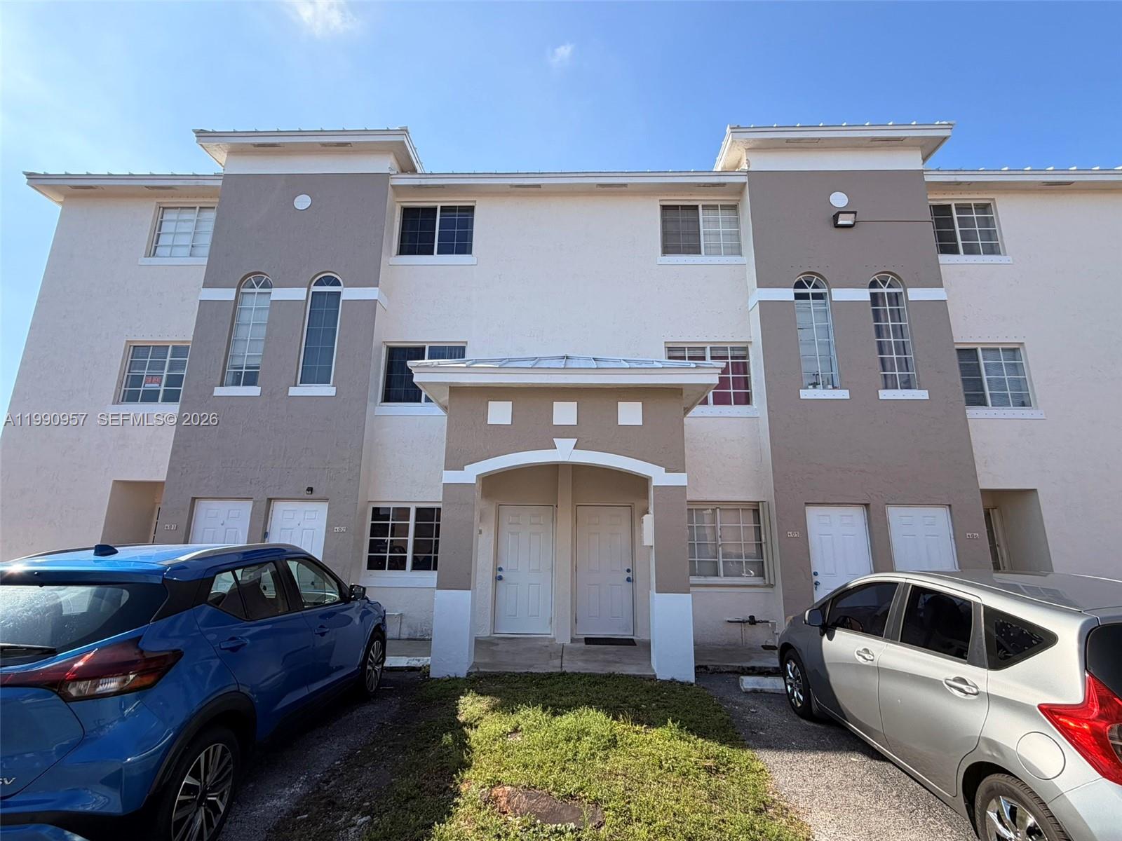 12005 Southwest 14th Street, Unit 403D Miami, FL 33184 - Photo 1 of 26 a front view of a house with garden