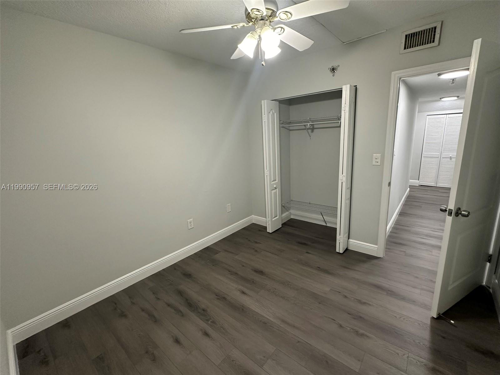 12005 Southwest 14th Street, Unit 403D Miami, FL 33184 - Photo 16 of 26 a view of an empty room with wooden floor