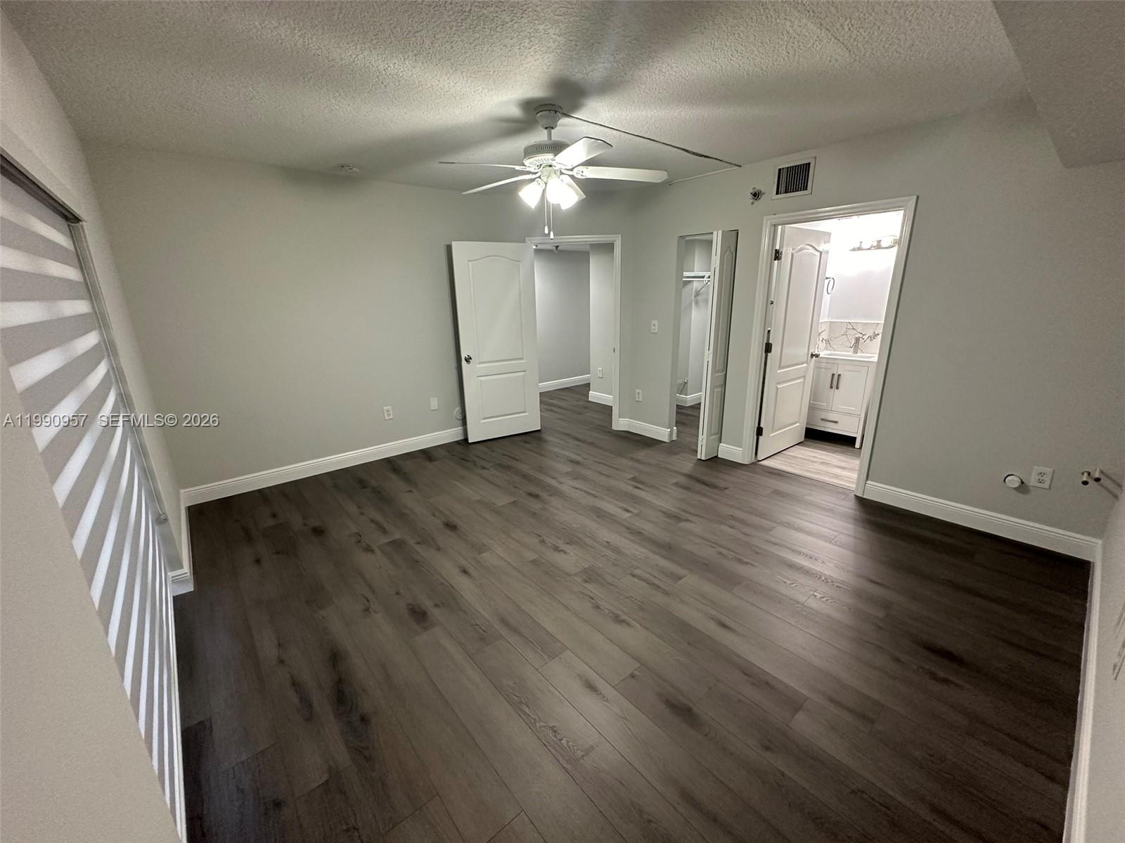 12005 Southwest 14th Street, Unit 403D Miami, FL 33184 - Photo 18 of 26 wooden floor in an empty room with a window