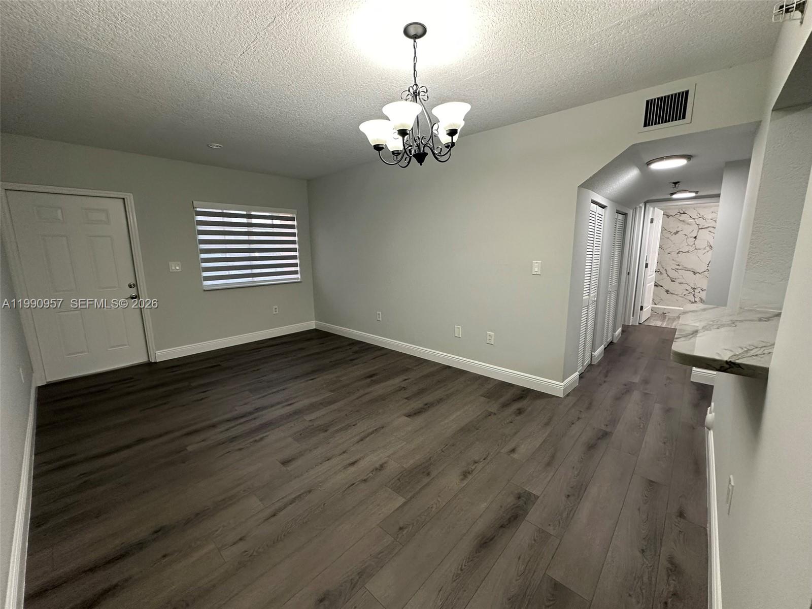 12005 Southwest 14th Street, Unit 403D Miami, FL 33184 - Photo 2 of 26 a view of a livingroom with a chandelier