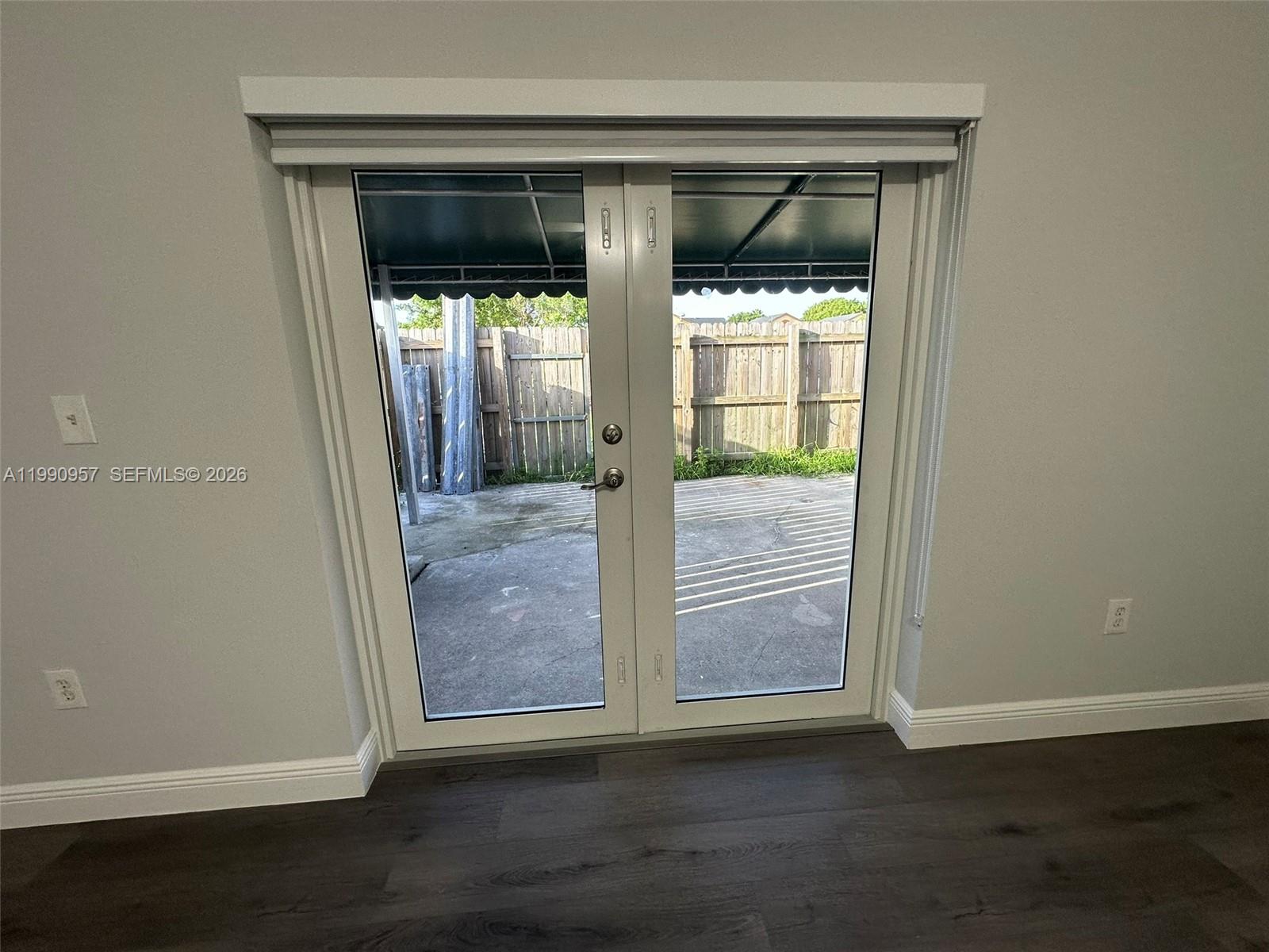 12005 Southwest 14th Street, Unit 403D Miami, FL 33184 - Photo 22 of 26 an empty room with wooden floor and windows
