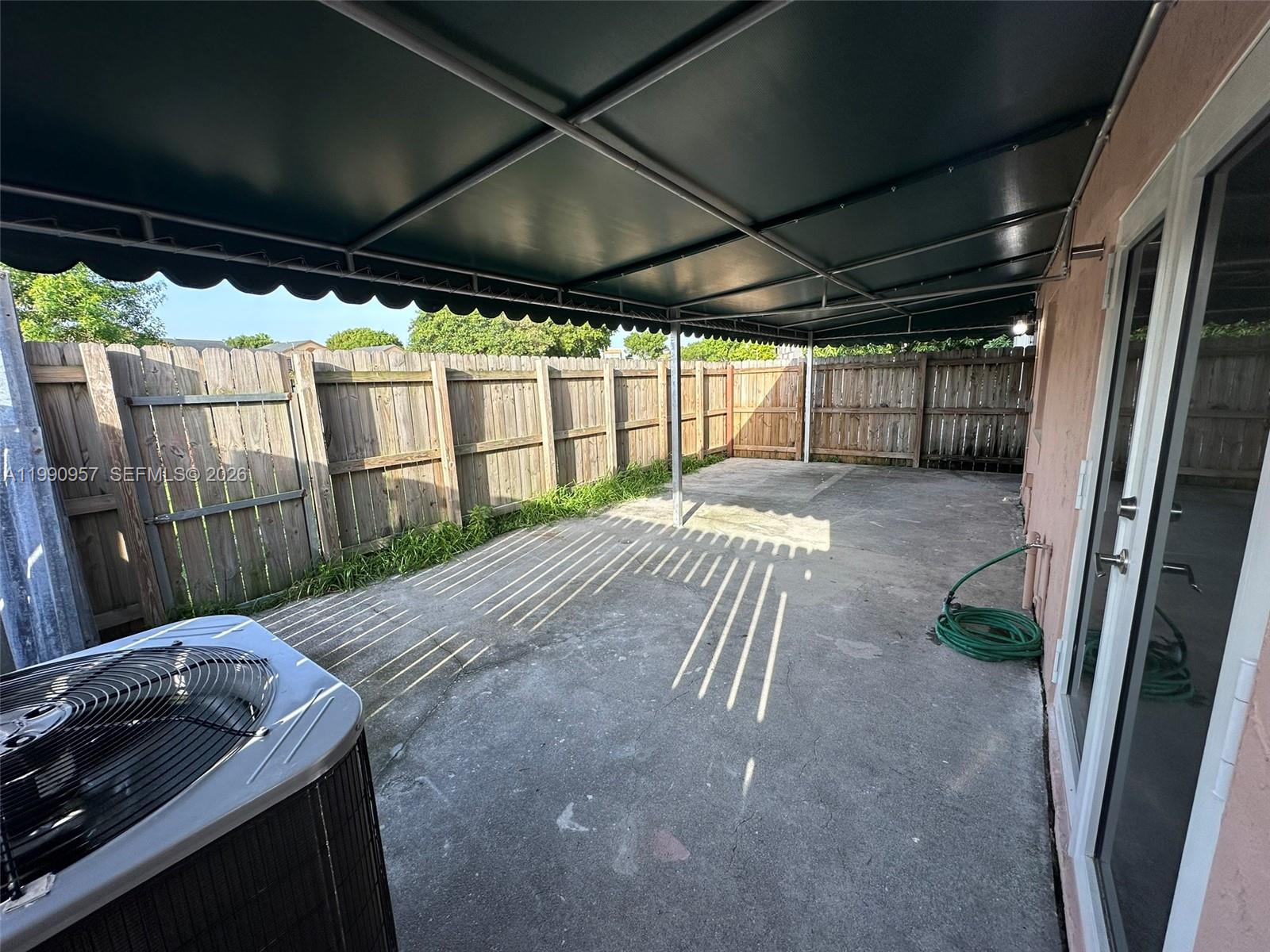 12005 Southwest 14th Street, Unit 403D Miami, FL 33184 - Photo 24 of 26 a backyard of a house with table and chairs