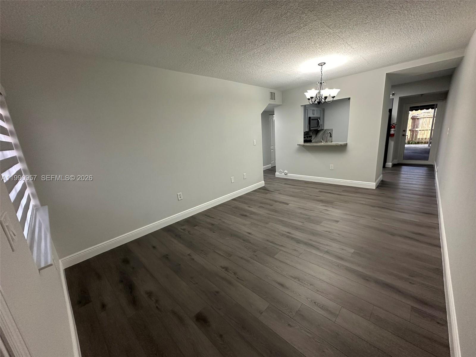 12005 Southwest 14th Street, Unit 403D Miami, FL 33184 - Photo 3 of 26 wooden floor in an empty room with a window