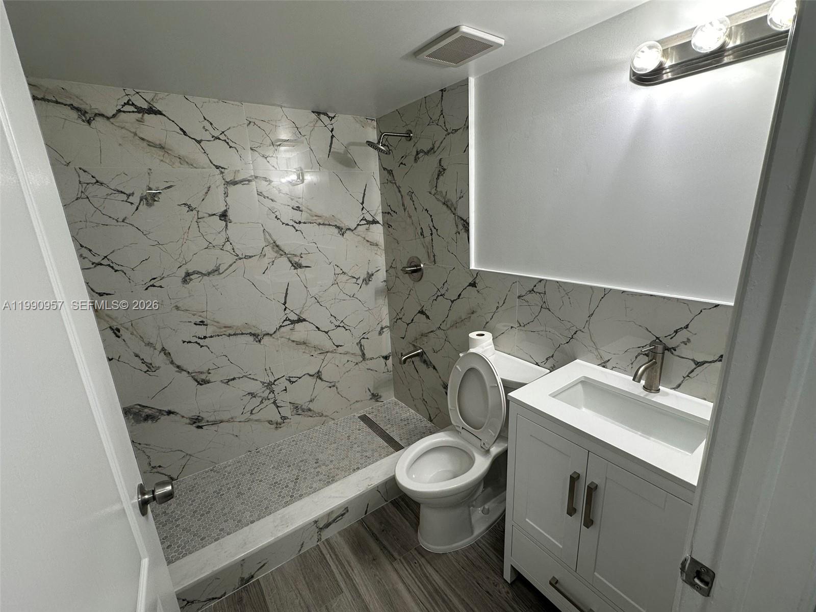 12005 Southwest 14th Street, Unit 403D Miami, FL 33184 - Photo 8 of 26 a bathroom with a sink toilet and shower