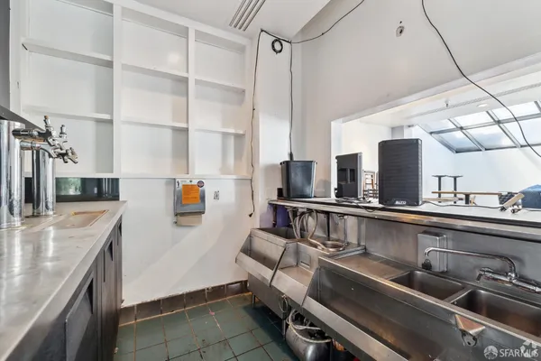 a kitchen with a sink and a stove top oven