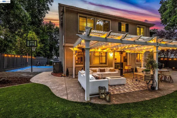 a view of a house with backyard porch and sitting area
