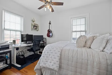 a bedroom with a bed and a desk