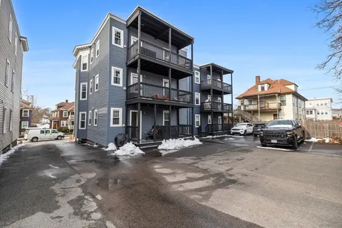 a view of a street that has couple of cars parked on the road