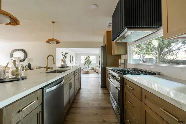 a kitchen with sink stove and cabinets
