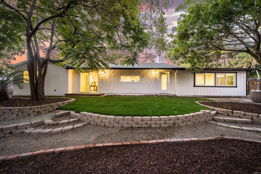 2275 Ivy Road Oceanside, CA 92054 - Photo 2 of 45 a front view of a house with a yard and garage