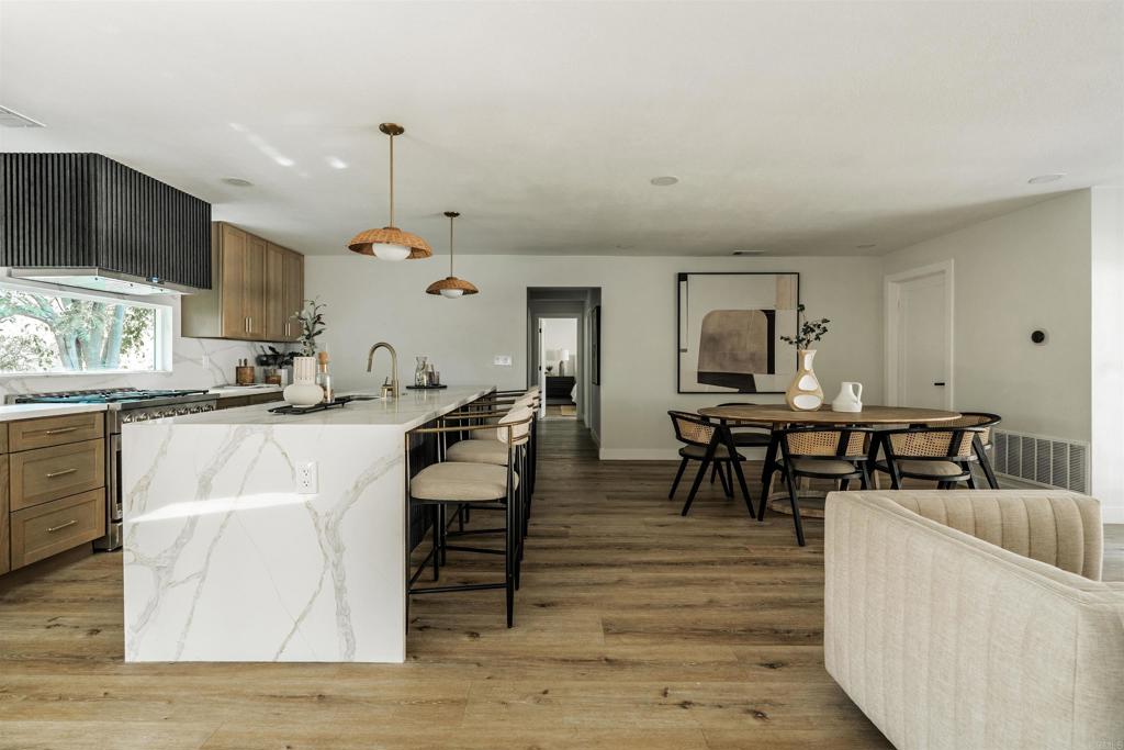 2275 Ivy Road Oceanside, CA 92054 - Photo 25 of 45 a living room with couches chairs and kitchen view with wooden floor