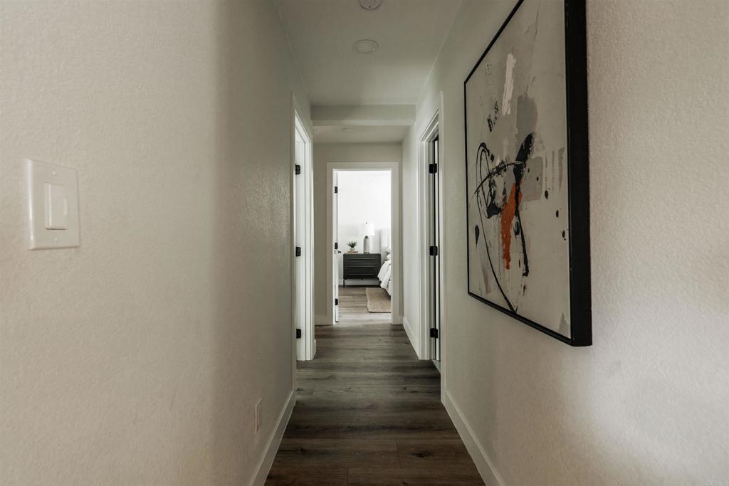 2275 Ivy Road Oceanside, CA 92054 - Photo 29 of 45 a view of a hallway with wooden floor and stairs