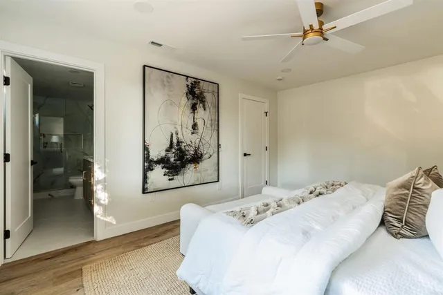 a bedroom with a bed and a painting on the wall