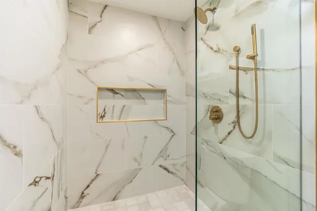 a bathroom with a glass shower door