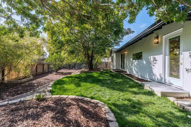a view of a house with backyard and sitting area