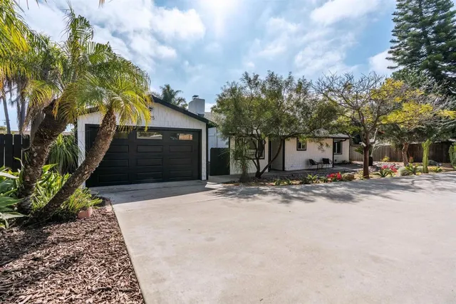 a view of a house with a yard and garage