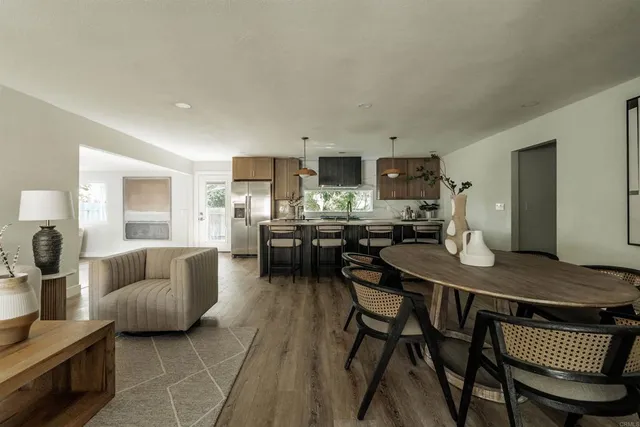 a living room with furniture and kitchen view
