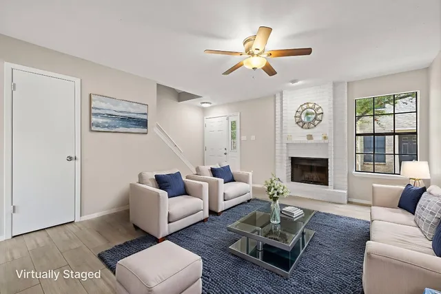 a living room with furniture fireplace and window
