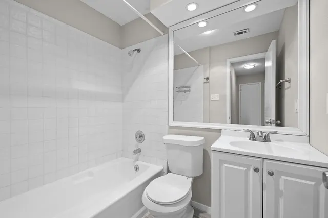 a bathroom with a sink toilet vanity and shower
