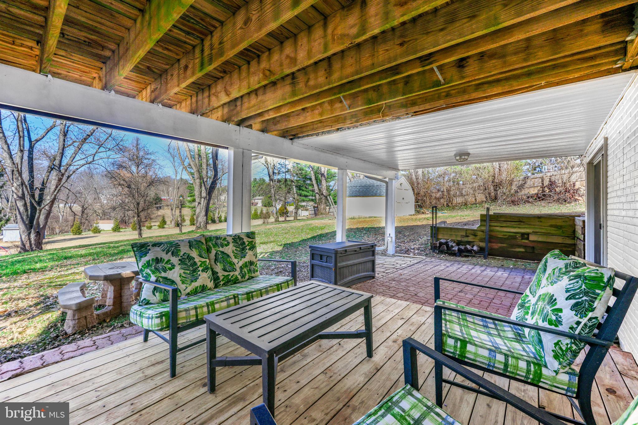 612 Ridge Road Finksburg, MD 21048 - Photo 13 of 39 a view of a patio with table and chairs potted plants with wooden floor and fence