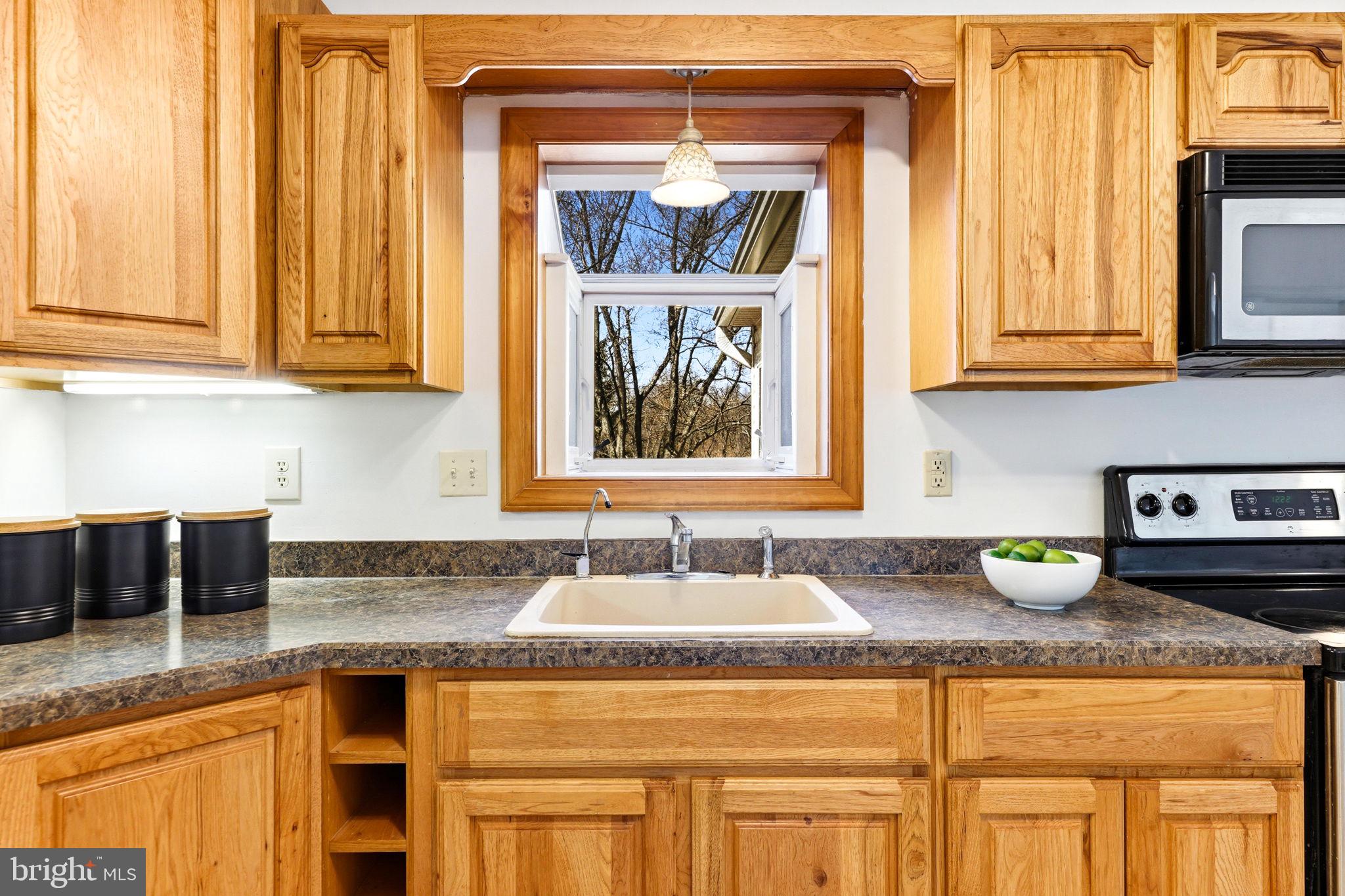 612 Ridge Road Finksburg, MD 21048 - Photo 22 of 39 a kitchen with granite countertop a sink a stove and cabinets