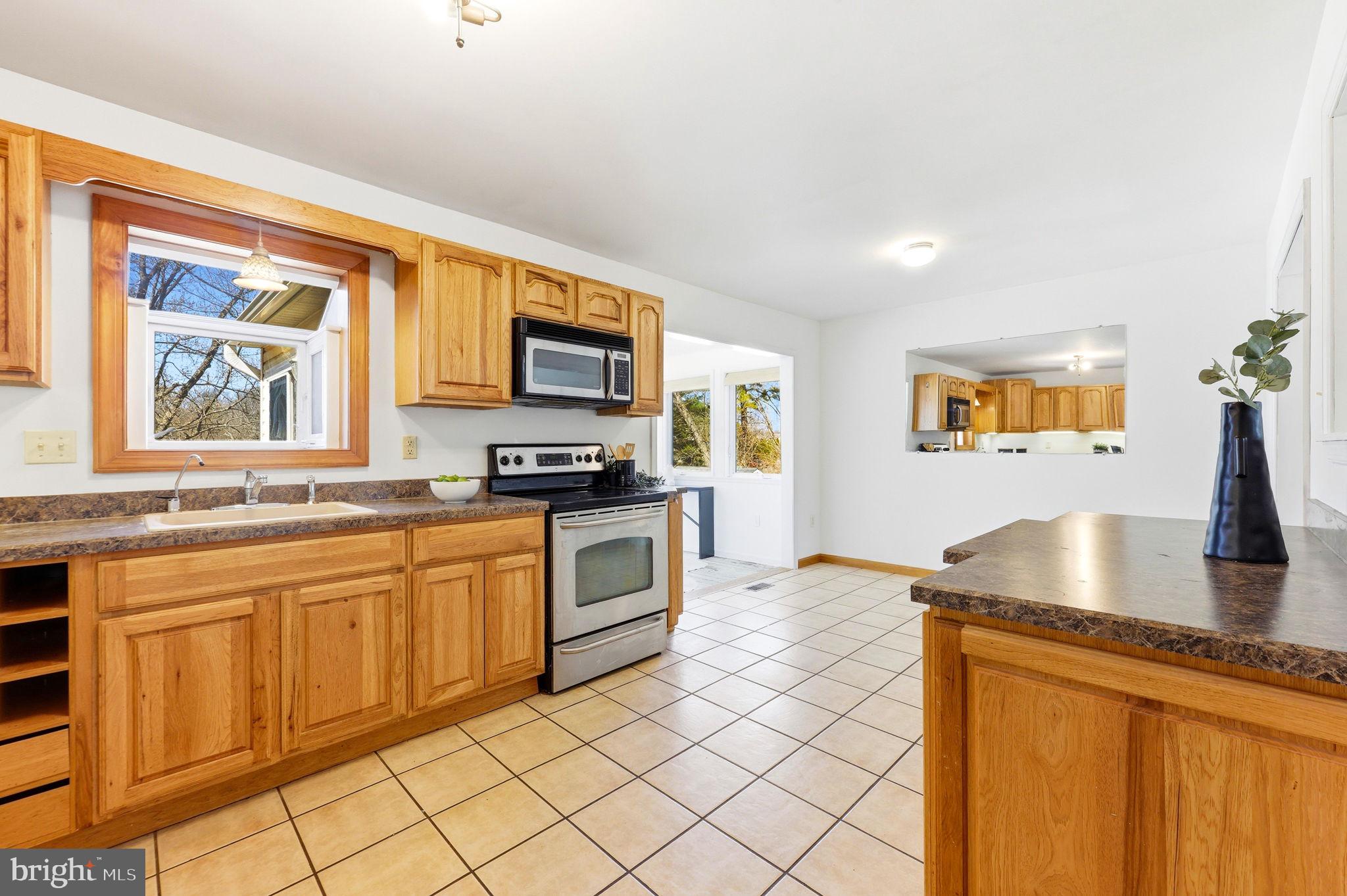612 Ridge Road Finksburg, MD 21048 - Photo 24 of 39 a kitchen with granite countertop a sink cabinets and window