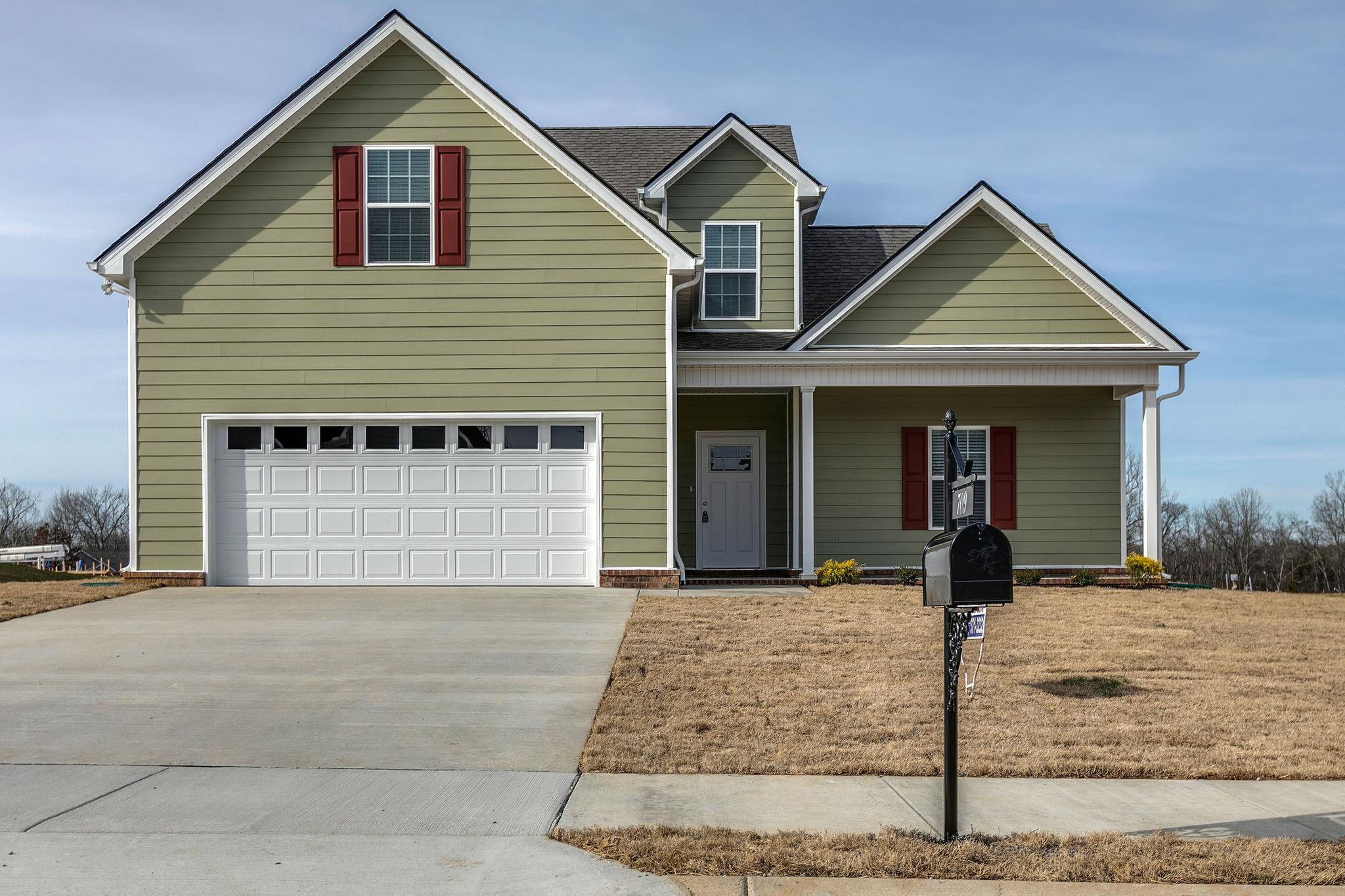709 Mitscher Drive Spring Hill, TN 37174 - Photo 1 of 27 a front view of a house with yard