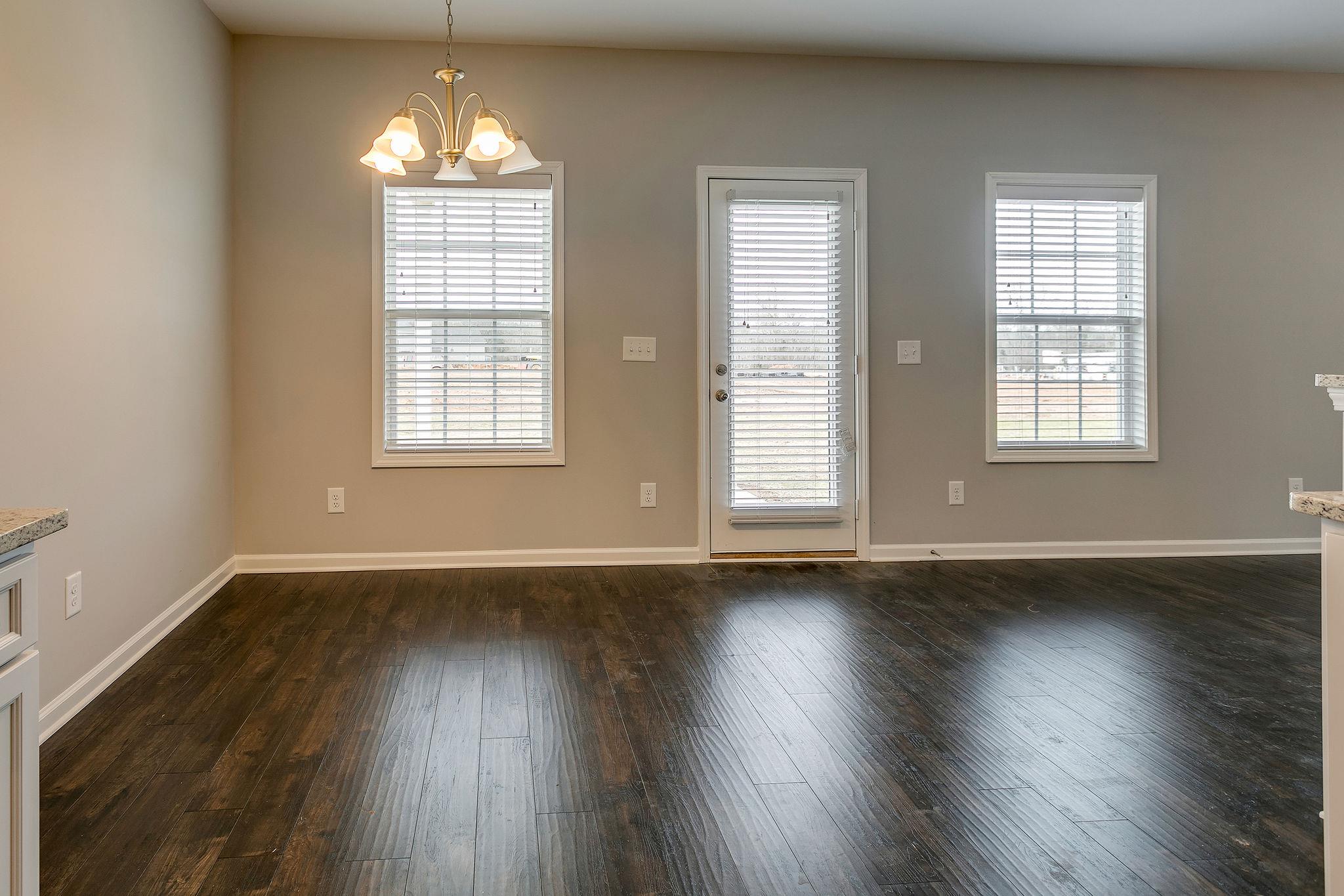 709 Mitscher Drive Spring Hill, TN 37174 - Photo 10 of 27 an empty room with wooden floor and windows