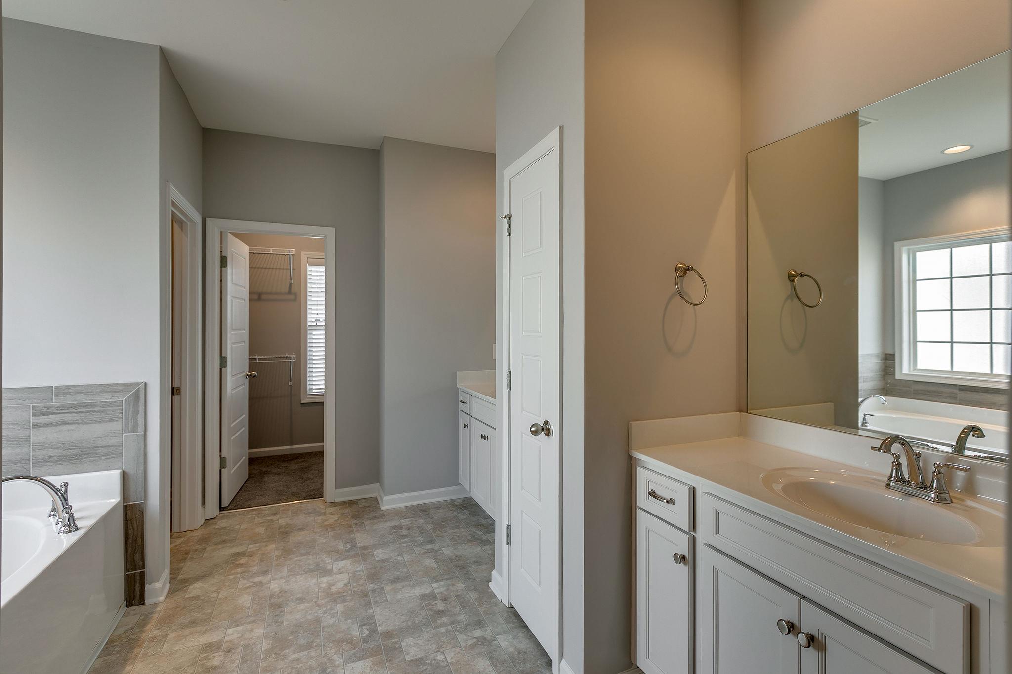 709 Mitscher Drive Spring Hill, TN 37174 - Photo 13 of 27 a bathroom with a sink and a large mirror