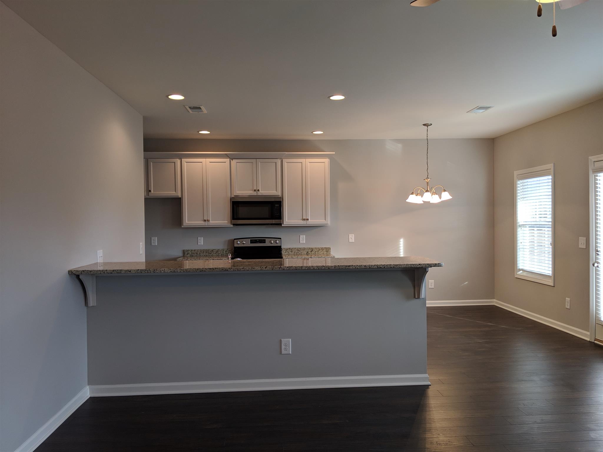 709 Mitscher Drive Spring Hill, TN 37174 - Photo 14 of 27 a kitchen with stainless steel appliances a microwave sink and cabinets