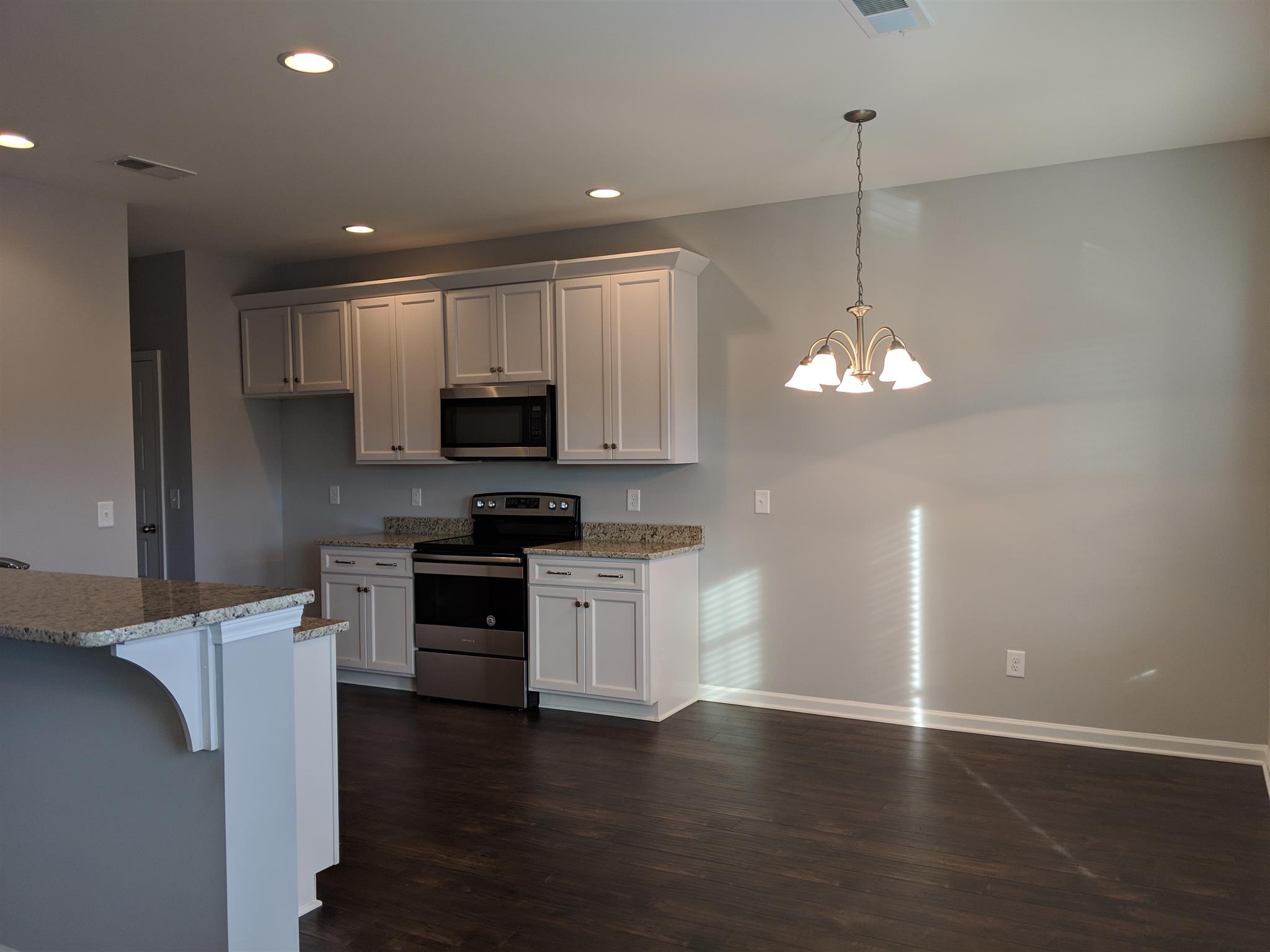 709 Mitscher Drive Spring Hill, TN 37174 - Photo 15 of 27 a kitchen with stainless steel appliances granite countertop a refrigerator a stove oven a sink dishwasher and a wooden cabinets with wooden floor
