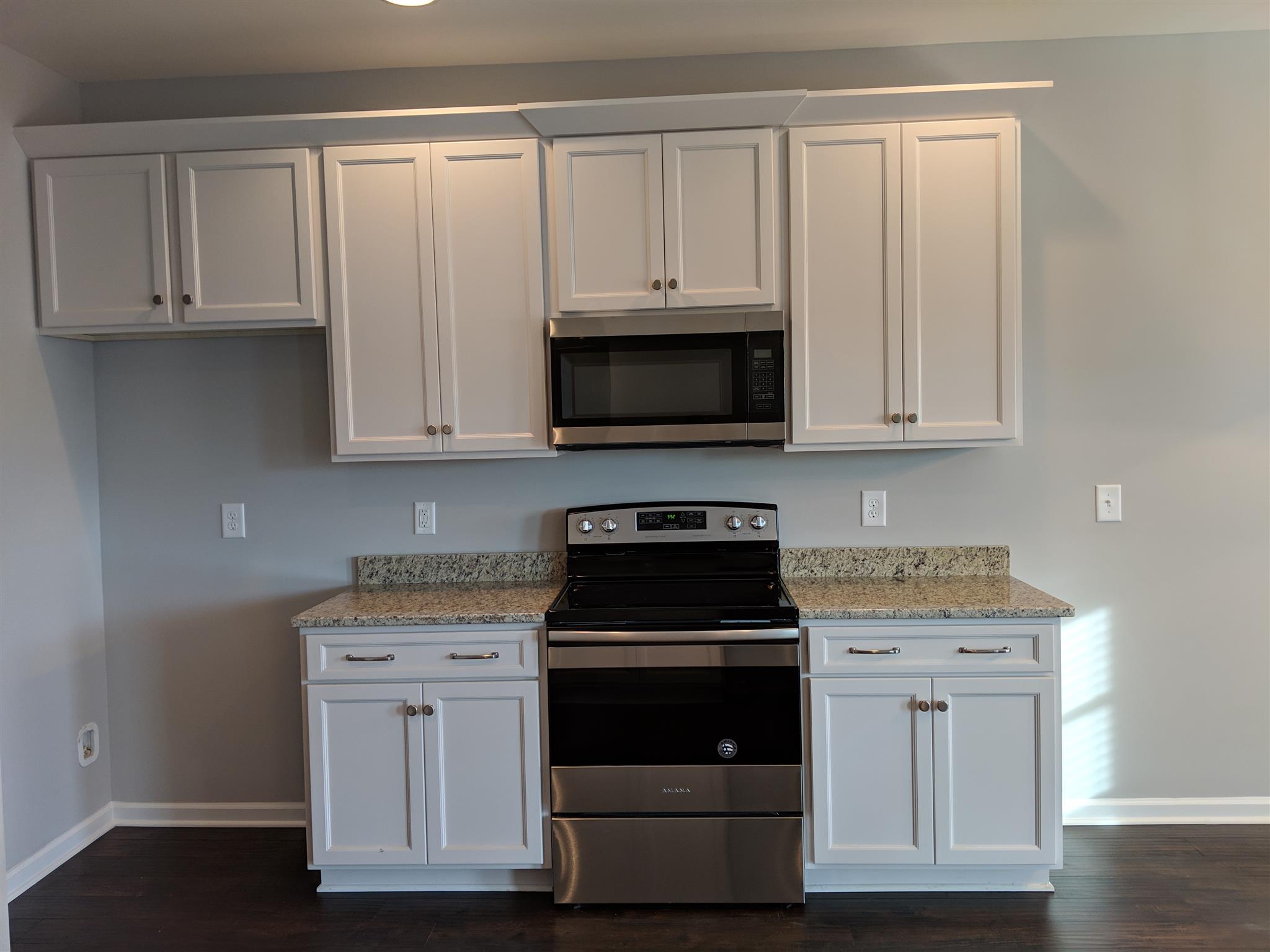 709 Mitscher Drive Spring Hill, TN 37174 - Photo 17 of 27 a kitchen with white cabinets and stainless steel appliances